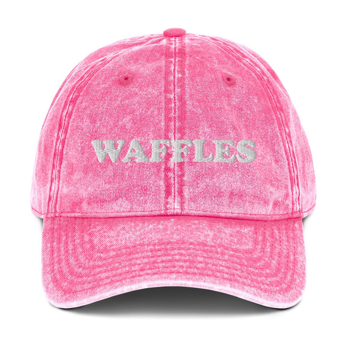 Pink denim dad hat for waffle lovers - The Waffles Dad Hat! This funny food dad hat is the perfect everyday accessory to show off your love of waffles. Wear the unique foodie dad hat for any occasion or give it as a stylish weird gift for a waffle lover. Show off your love of waffles and favorite foods in our vintage style weird dad hats and clothing.