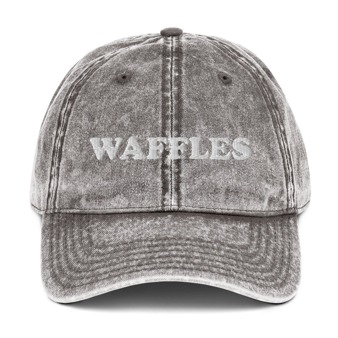 Gray washed out denim dad hat for waffle lovers - The Waffles Dad Hat! This funny food dad hat is the perfect everyday accessory to show off your love of waffles. Wear the unique foodie dad hat for any occasion or give it as a stylish weird gift for a waffle lover. Show off your love of waffles and favorite foods in our vintage style weird dad hats and clothing.