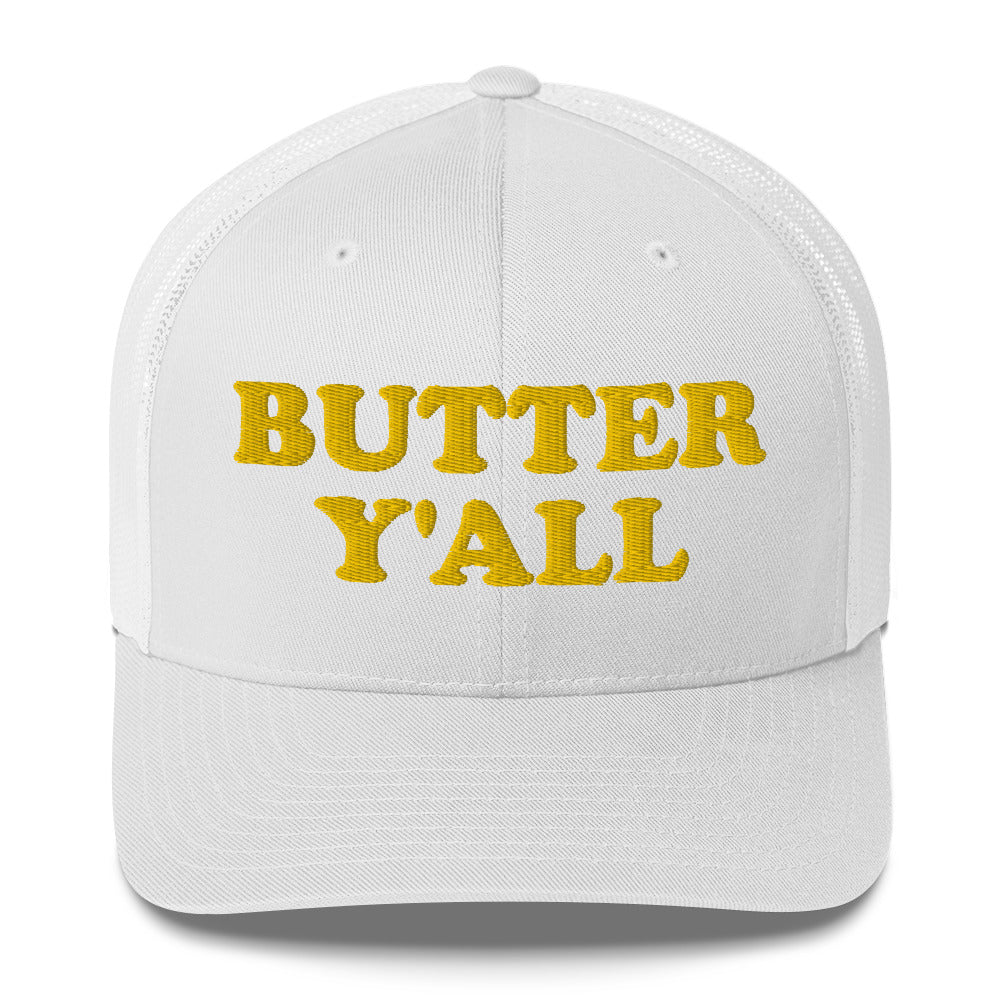 White Butter Hat - Are you a butter enthusiast? Looking for a funny gift? Our Butter Y'all Hat is comfortable and made just for you. It comes in a variety of colors with a funny butter phrase, expertly embroidered on the front. Make a statement and eat your favorite buttery foods in our butter y'all trucker hat. Edit alt text