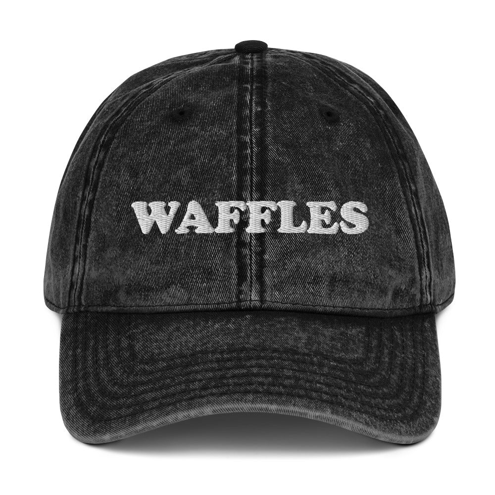 Black vintage style waffles dad hat - The Waffles Dad Hat! This funny food dad hat is the perfect everyday accessory to show off your love of waffles. Wear the unique foodie dad hat for any occasion or give it as a stylish weird gift for a waffle lover. Show off your love of waffles and favorite foods in our vintage style weird dad hats and clothing.
