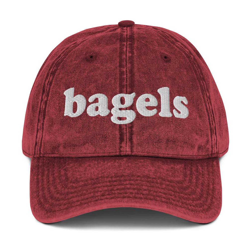Maroon Bagels hat - Make a statement in our Bagels Hat! It's comfortable, adjustable and made with a vintage style cotton that's expertly embroidered just for you. This funny dad hat is perfect for bagel enthusiasts and foodies of all kinds. Looking for something personalized? Shoot us a message!