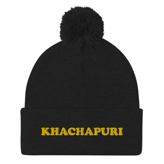 Black beanie with khachapuri emboidery - We love khachapuri! This khachapuri hat is a comfortable and unusual foodie beanie with a classic pom pom on top and a funky yellow embroidery. The beanie is cozy and just what every foodie and khachapuri lover needs. Celebrate your love for khachapuri and Georgean food in this this funky food beanie hat.