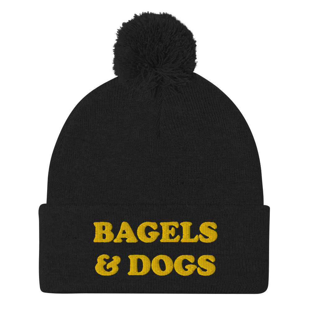 Black Bagels and dogs beanie. Get your priorities straight - Keep your priorities in check with this bagels and dogs beanie with a pom pom on top. It's a unique and funny beanie for foodies and animal lover. Now you can eat bagels and pet dogs in a cozy hat that makes people smile. Stay weird and celebrate your favorite foods and animals in our funky clothing and accessories.