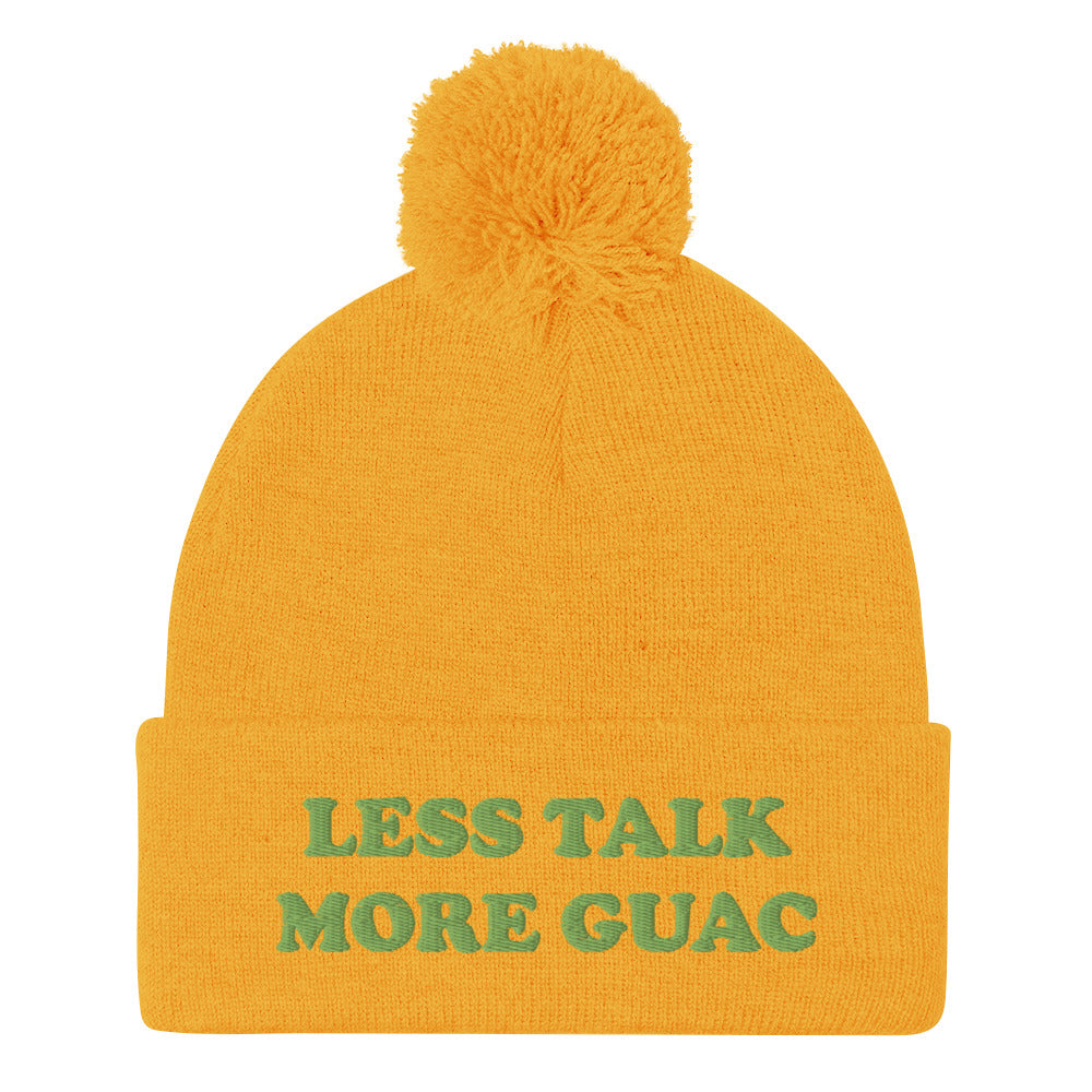 Yellow guacamole beanie with green embroidery. Less talk more guac! Make your priorities clear in this unique guacamole beanie hat. It's a classic pom pom beanie with a funky foodie yellow embroidery. This funny food quote hat is a perfect foodie beanie or unique gift for guacamole lovers. Now you can wear a funky guacamole quote hat and eat guacamole in style.
