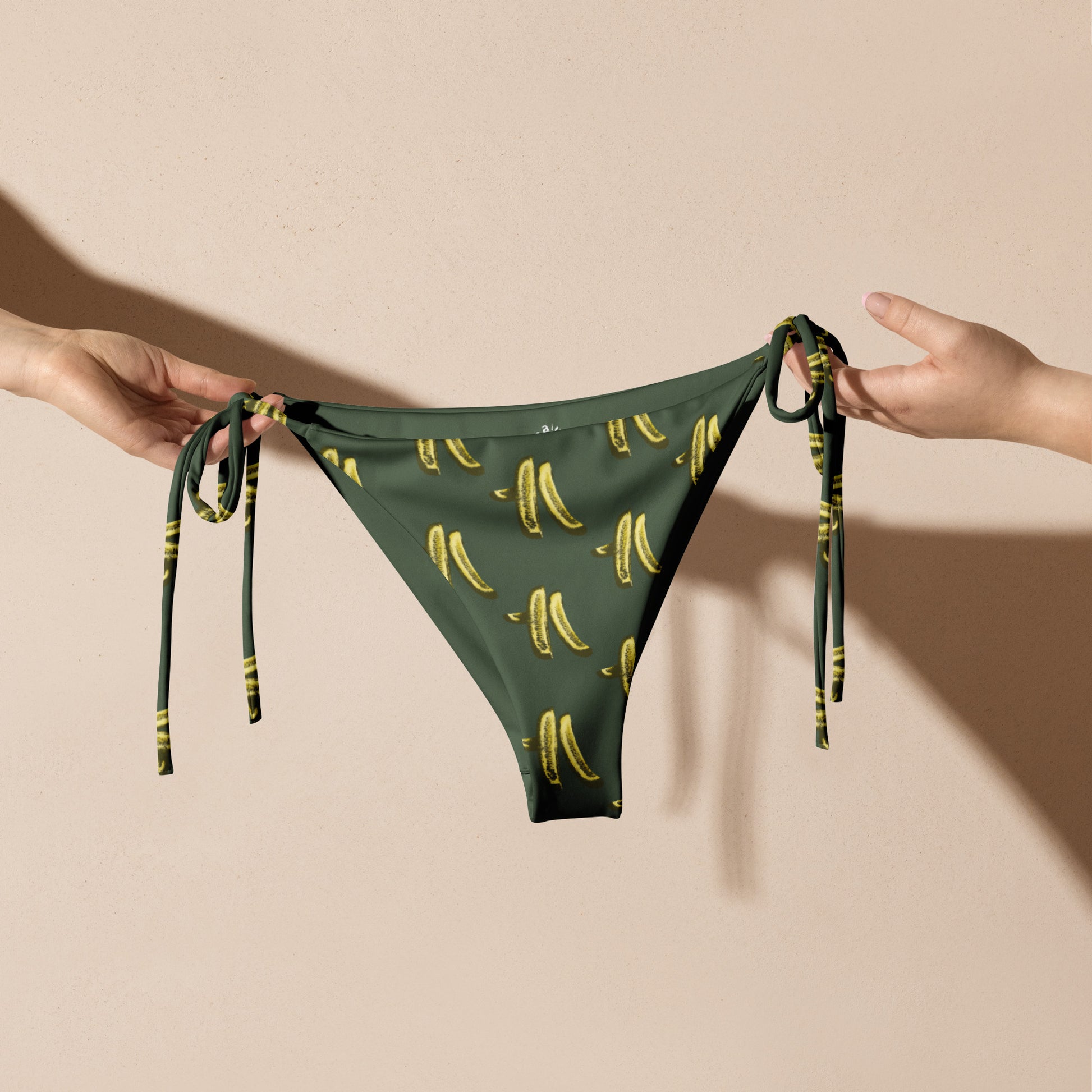 Green Pickles Bikini - Did someone say pickles? This summer, sit back and relax by the water in our Recycled String Bikini Bottom with a pickles design. It's made of soft, stretchy recycled polyester with UPF 50+. Our unique pickles bikini is just what every pickle enthusiast needs!