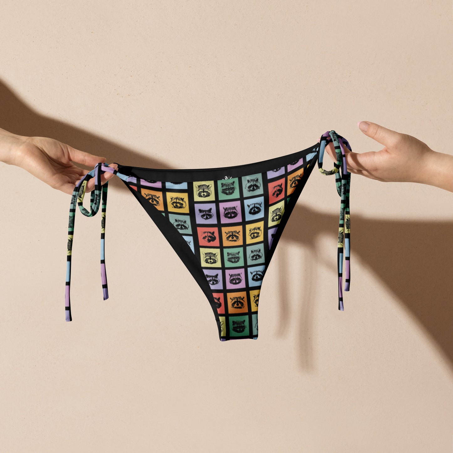 Love raccoons? Looking for your new favorite eco friendly bikini? Sit back and relax by the poolside wearing this classic string bikini with a colorful raccoon design. Our raccoon bikini is made of soft and stretchy recycled polyester with UPF 50+. Perfect for the beach, the pool and everything in between, or a funny gift for a raccoon enthusiast! 