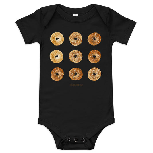 Black Bagel Onesie for Babies with funny design - Love bagels? Dress your baby in our 100% cotton bagel baby onesie. It has three snap leg closure for easy changing, a comfortable envelope neckline, and a unique bagel design, expertly printed on the front. Designed by Nina and made just for you!