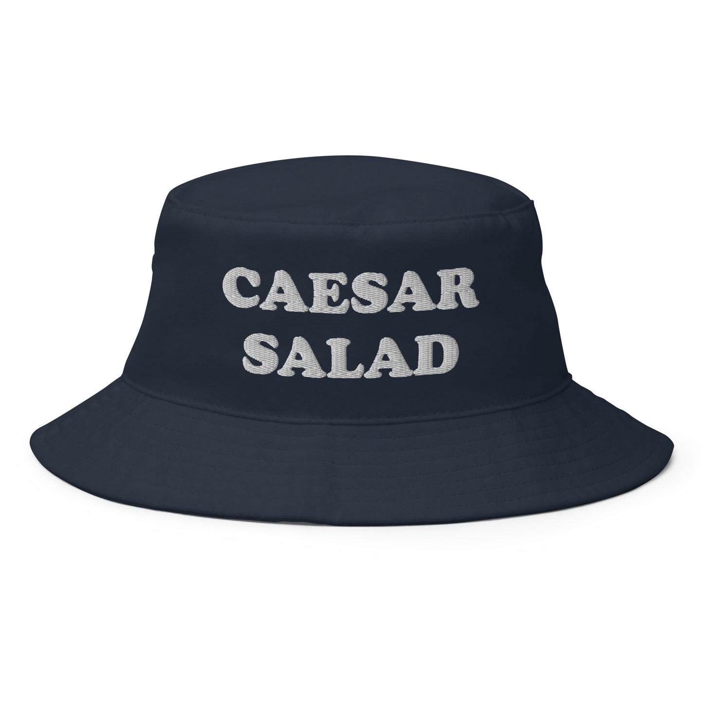 Navy Caesar Salad Bucket Hat - Love Caesar Salad? Looking for a funny foodie hat? This Caesar Salad Bucket Hat is just what you need! It's comfortable and comes in a variety of colors with "Caesar Salad", expertly embroidered across the front. The perfect weird hat for Salad enthusiasts and foodies of all kinds. Celebrate your favorite foods in our funky foodie clothing and accessories. 