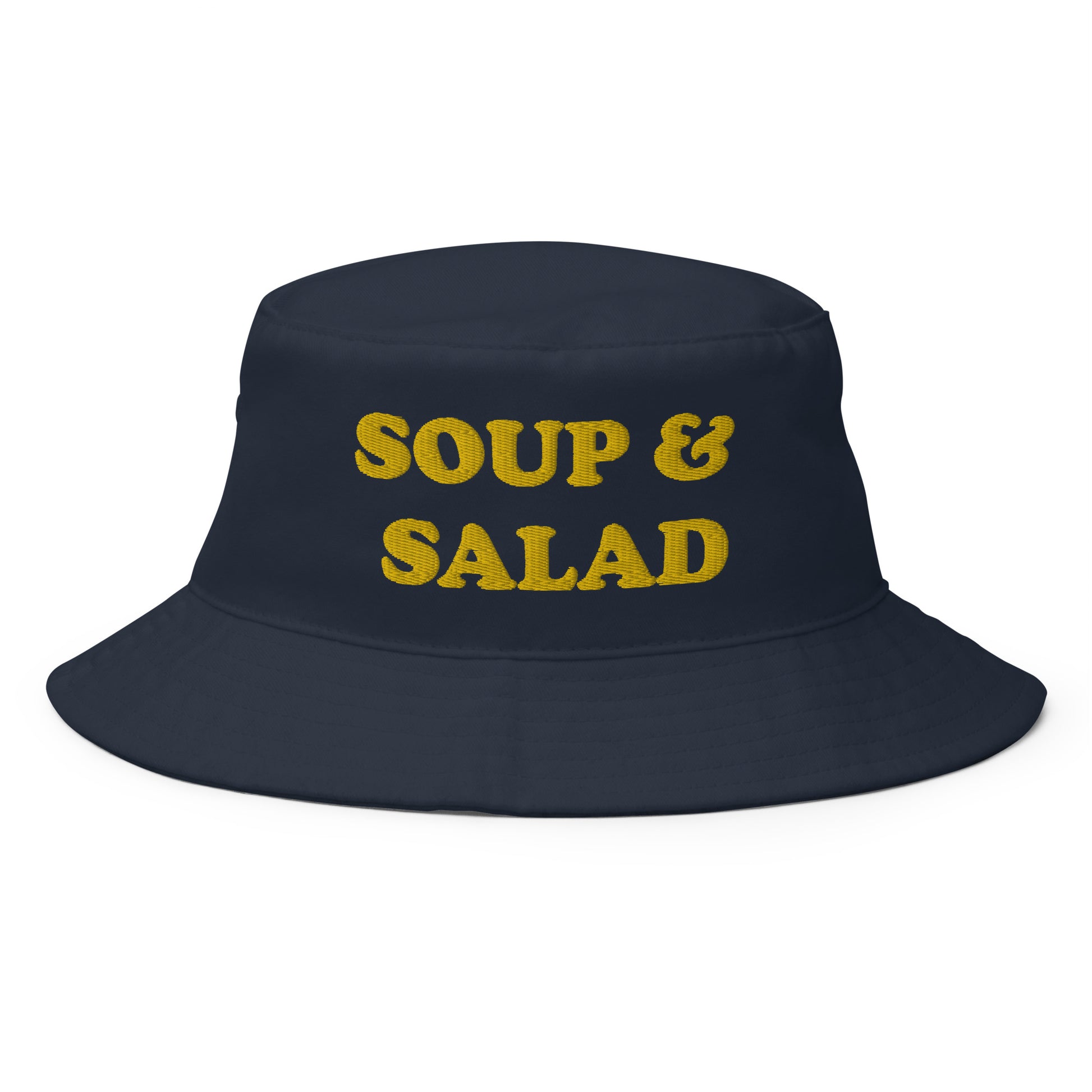 Navy Soup and Salad Hat -- Make a statement in our Soup & Salad Bucket Hat. It's comfortable and comes in a variety of colors with a a funny foodie design, expertly embroidered across the front. The perfect bucket hat for everything from beach adventures to grocery shopping. Eat your favorite foods in this funny hat or give it as a gift to your favorite soup and salad enthusiast. 