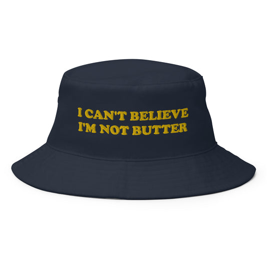 Navy I Can't Believe I'm Not Butter Bucket Hat - Our I Can't Believe I'm Not Butter Bucket Hat is comfortable and perfect for any occasion. It's a classic cotton bucket hat with a funny saying, expertly embroidered on the front. 