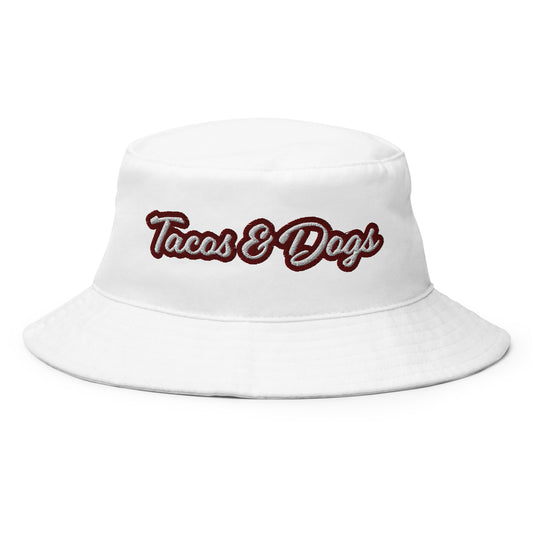 White Tacos and Dogs Bucket Hat - Love tacos? Big dog person? This funny bucket Hat is just what you need! Our Tacos & Dogs Bucket Hat is comfortable and comes in a variety of colors with a funny food design, expertly embroidered across the front. The perfect funny hat for dog lovers, taco enthusiasts and foodies of all kinds. Celebrate your favorite foods in our funky foodie clothing and accessories. 