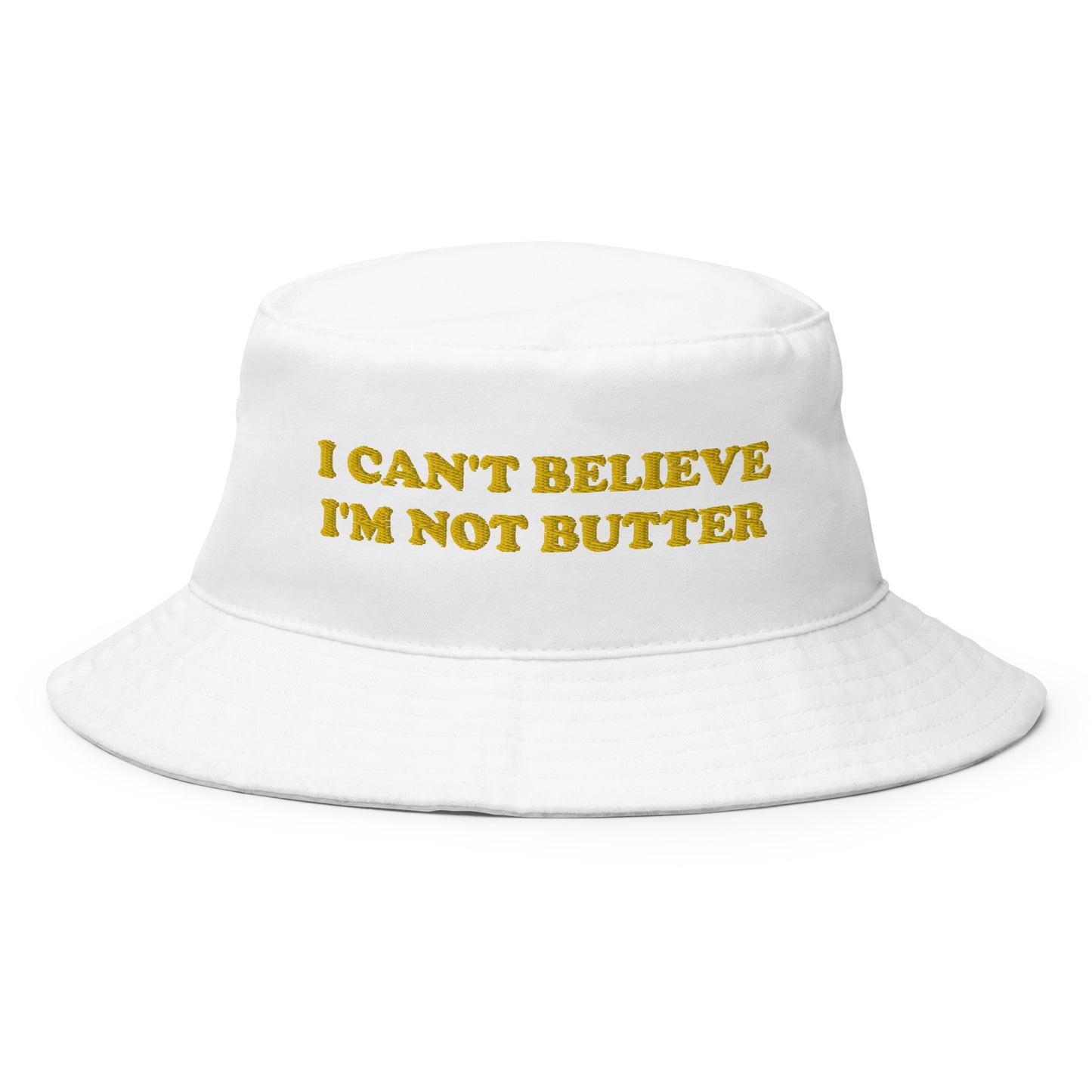 White I Can't Believe I'm Not Butter Bucket Hat - Our I Can't Believe I'm Not Butter Bucket Hat is comfortable and perfect for any occasion. It's a classic cotton bucket hat with a funny saying, expertly embroidered on the front.