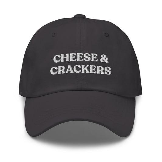 Dark Gray Cheese and Crackers Hat - If you love cheese and crackers, this funny foodie dad hat might be just what you need! Our Cheese & Crackers Hat is comfortable, adjustable and comes in a variety of colors. It's a classic dad hat embroidered with your favorite foods. Perfect for everyday streetwear or a gift for a charcuterie king or queen.