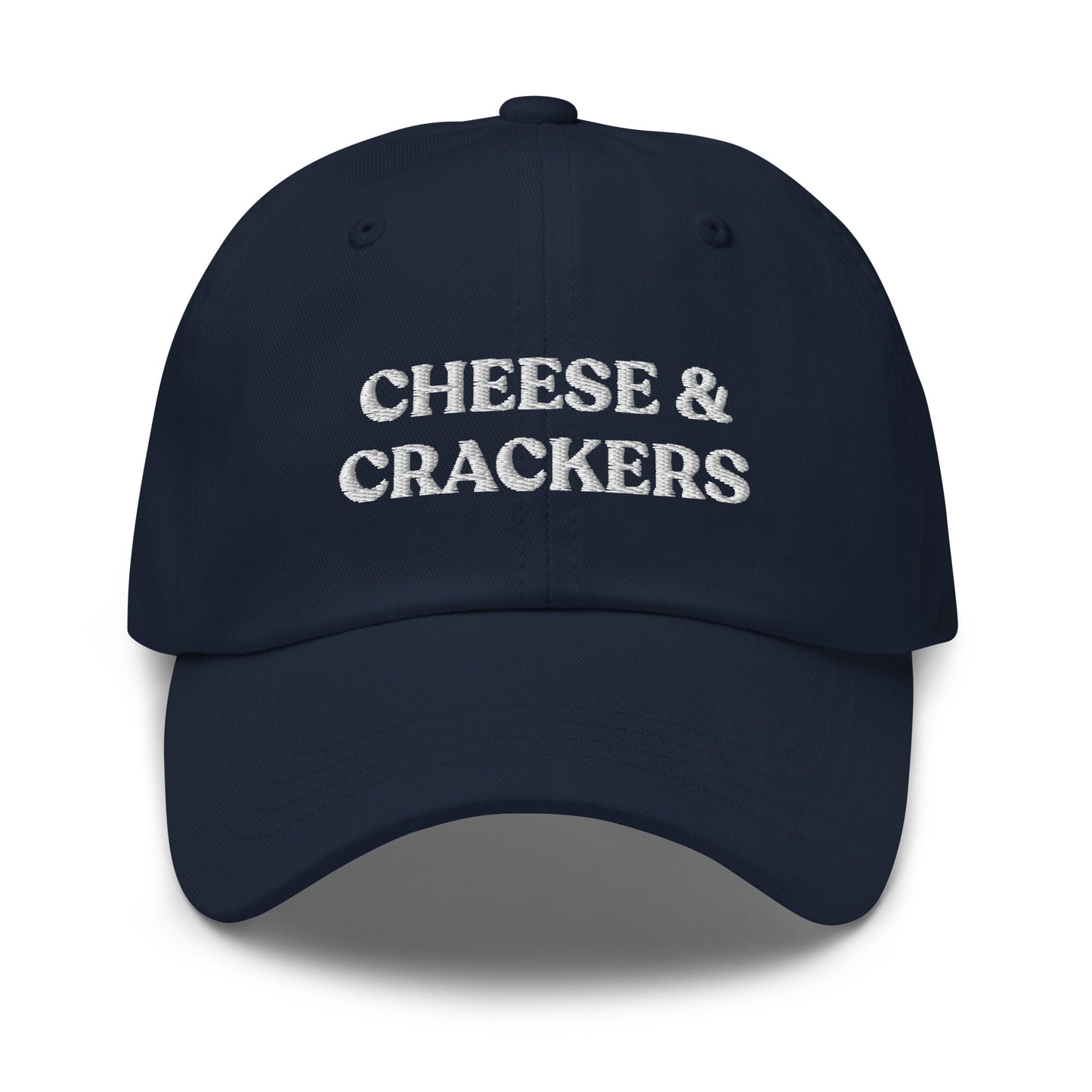 Navy Cheese and Crackers Hat - If you love cheese and crackers, this funny foodie dad hat might be just what you need! Our Cheese & Crackers Hat is comfortable, adjustable and comes in a variety of colors. It's a classic dad hat embroidered with your favorite foods. Perfect for everyday streetwear or a gift for a charcuterie king or queen.