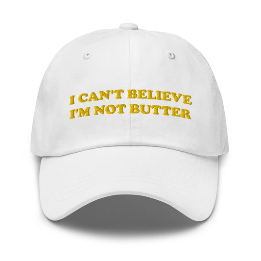 White I Can't Believe I'm Not Butter Hat - Our I can't believe I'm not butter hat is comfortable, comes in a variety of colors and has an adjustable closure. It's a classic dad hat with a funny saying, expertly embroidered on the front. Perfect for everyday streetwear and sure to turn heads and have everyone asking, "Where'd you get that hat?"