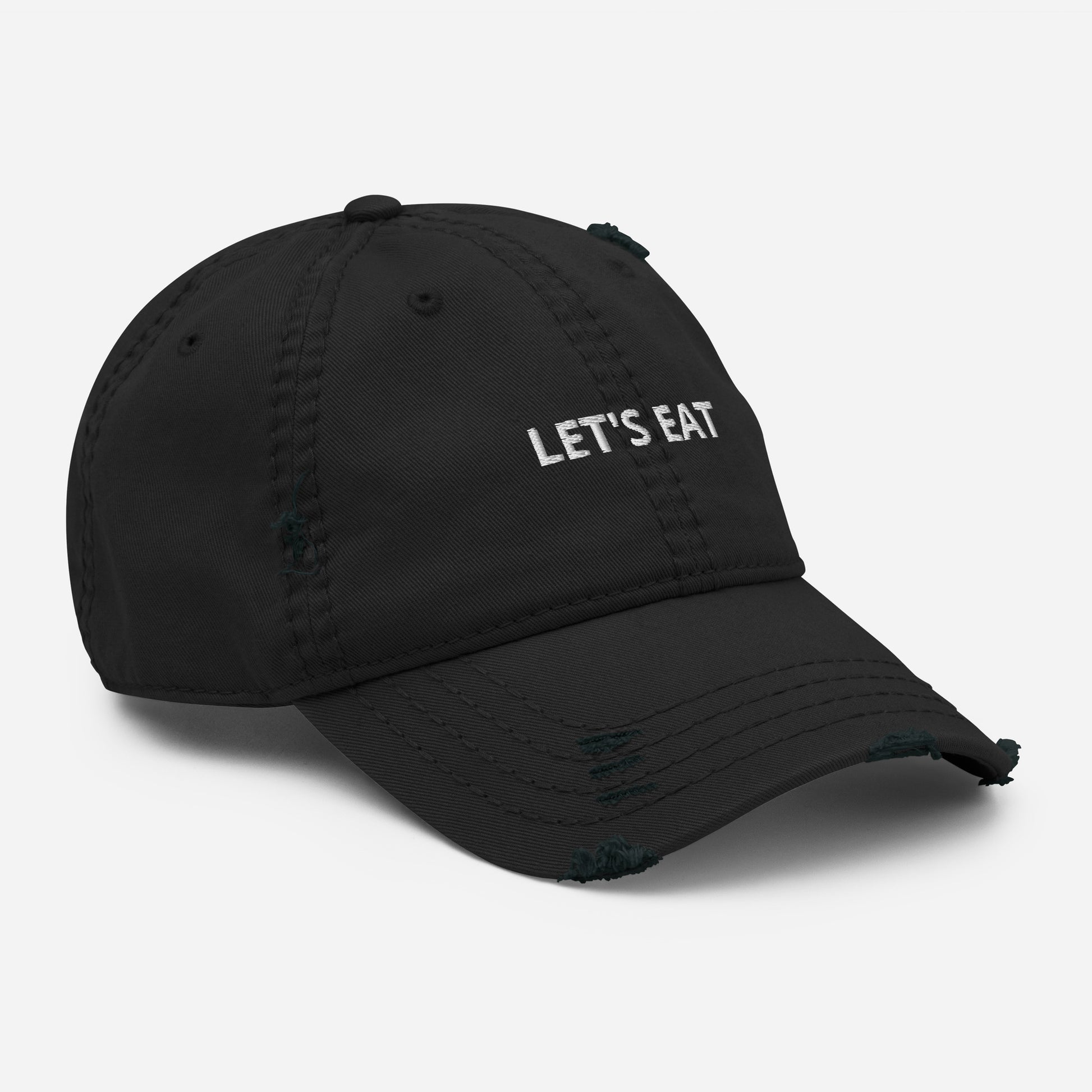 Black Let's Eat Hat - Let's Eat! Make a statement and find your people in our Let's Eat Hat. It's a classic dad hat, perfect for everyday streetwear or a gift for your favorite foodie. This funny food hat is comfortable, comes in a multiple colors and has an adjustable closure.