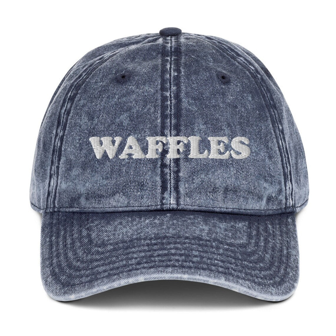 Blue waffles dad hat - washed out vintage style denim hat for foodies - The Waffles Dad Hat! This funny food dad hat is the perfect everyday accessory to show off your love of waffles. Wear the unique foodie dad hat for any occasion or give it as a stylish weird gift for a waffle lover. Show off your love of waffles and favorite foods in our vintage style weird dad hats and clothing. 