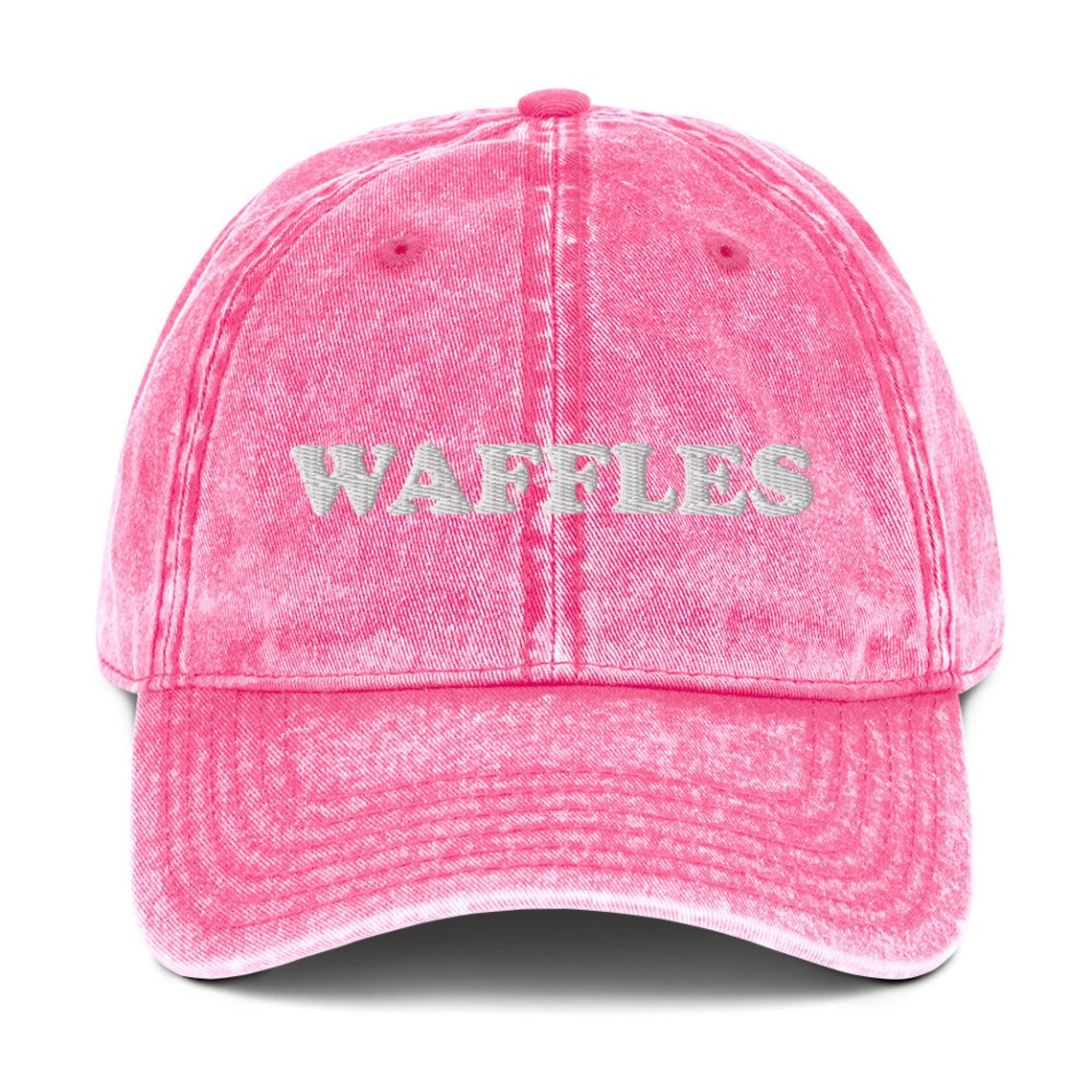 Pink denim dad hat for waffle lovers - The Waffles Dad Hat! This funny food dad hat is the perfect everyday accessory to show off your love of waffles. Wear the unique foodie dad hat for any occasion or give it as a stylish weird gift for a waffle lover. Show off your love of waffles and favorite foods in our vintage style weird dad hats and clothing. 