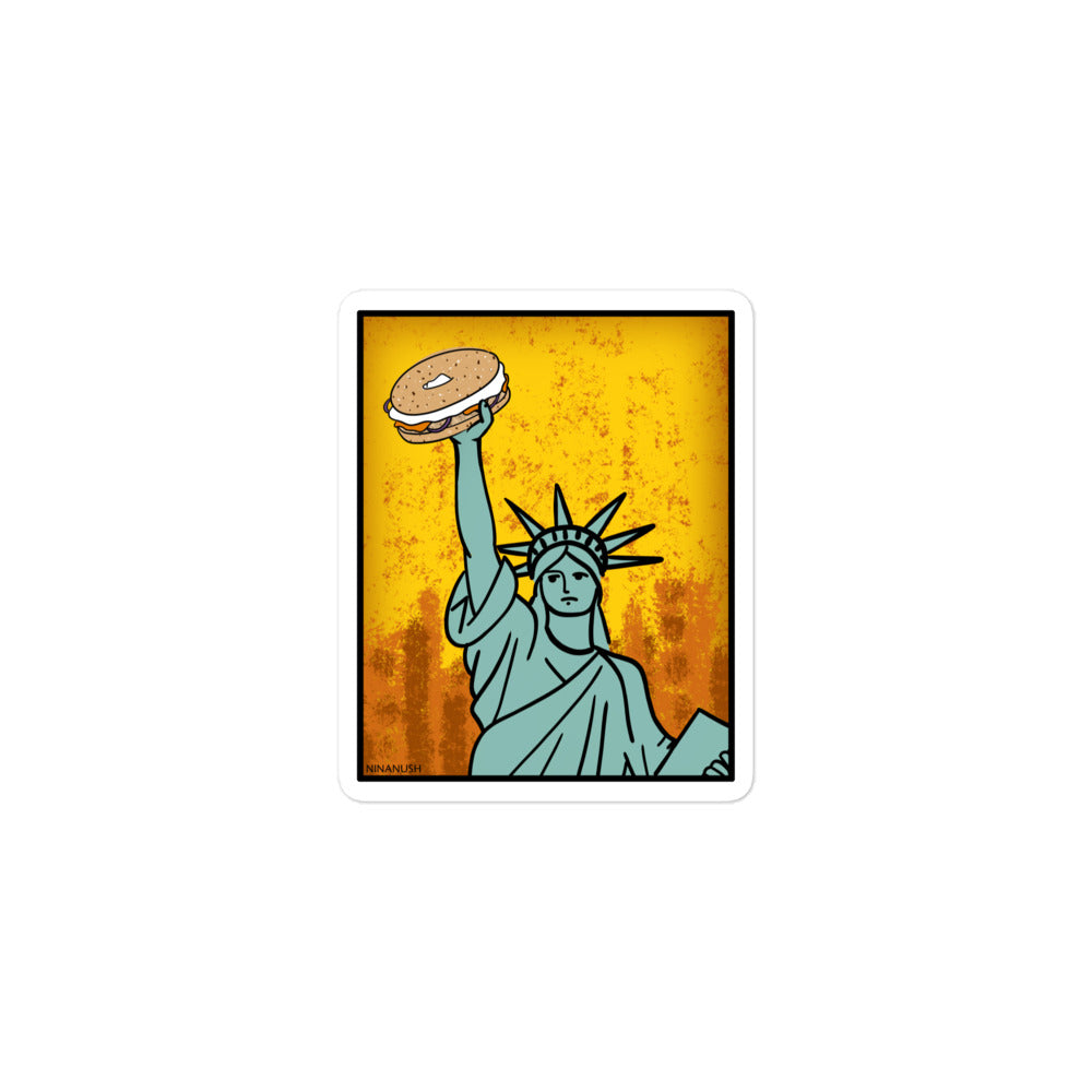 3x3 Statue of Liberty holding a bagel sticker from Nina's Funky Shop by ninanush - The New York Bagel Vinyl Sticker! Designed for bagel enthusiasts, this unique sticker has the Statue of Liberty holding a classic New York bagel. It's an original hand drawn design by Nina and it's made just for you. This funky bagel sticker is the perfect addition to your sticker collection or gift for a bagel lover.