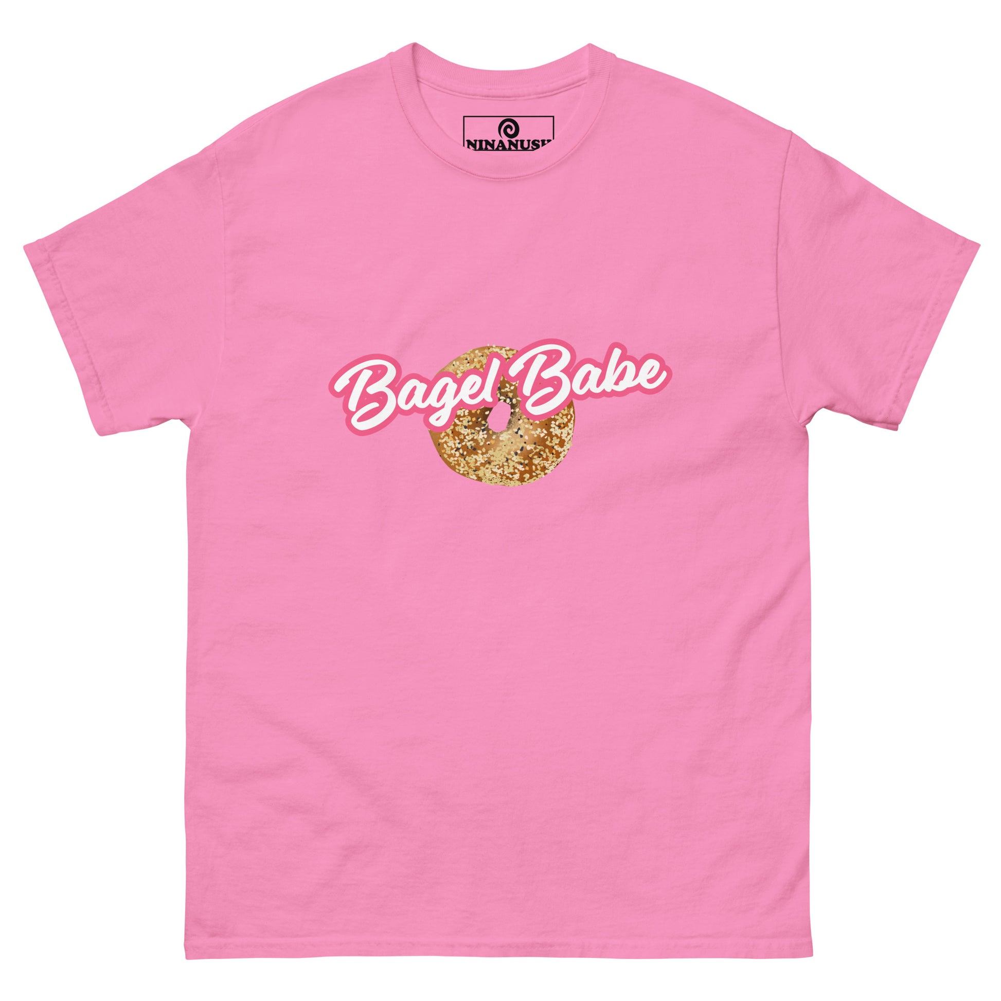 Pink bagel babe t-shirt from Nina's Funky Shop by ninanush - Eat bagels in this stand out bagel babe t-shirt. It's a cotton t-shirt with an everything bagel and the words "bagel babe" in Barbie style font. It has a structured streetwear design for bagel enthusiasts and made just for you. Eat bagels in style in this funny foodie t-shirt or give it as a gift to a bagel babe. 