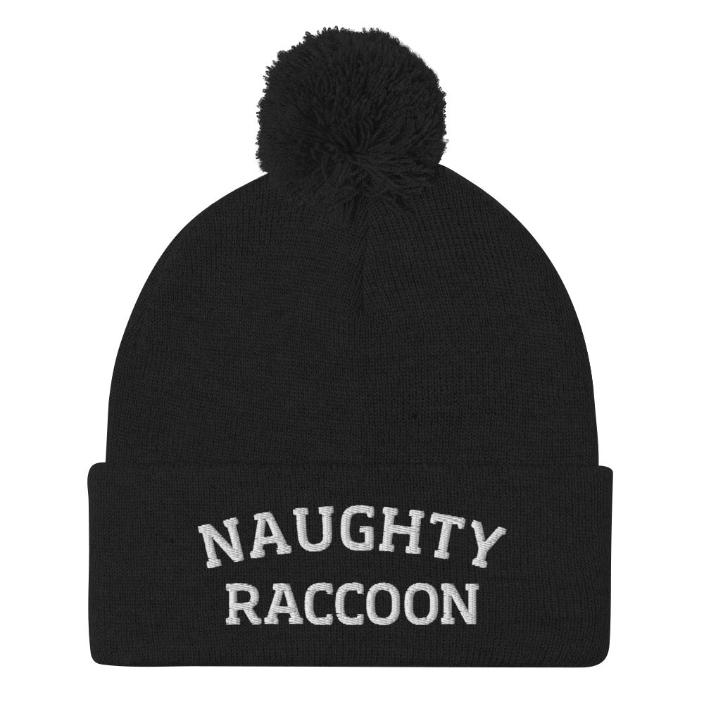 Black naughty raccoon beanie from Nina's Funky Shop by ninanush - This Naughty Raccoon hat is warm, cozy, designed by Nina and made just for you. It's a comfortable unisex beanie with a pom pom on top, expertly embroidered with the words "naughty raccoon". The perfect weird beanie for raccoon enthusiasts and funny hat for quirky accessory lovers of all kinds.