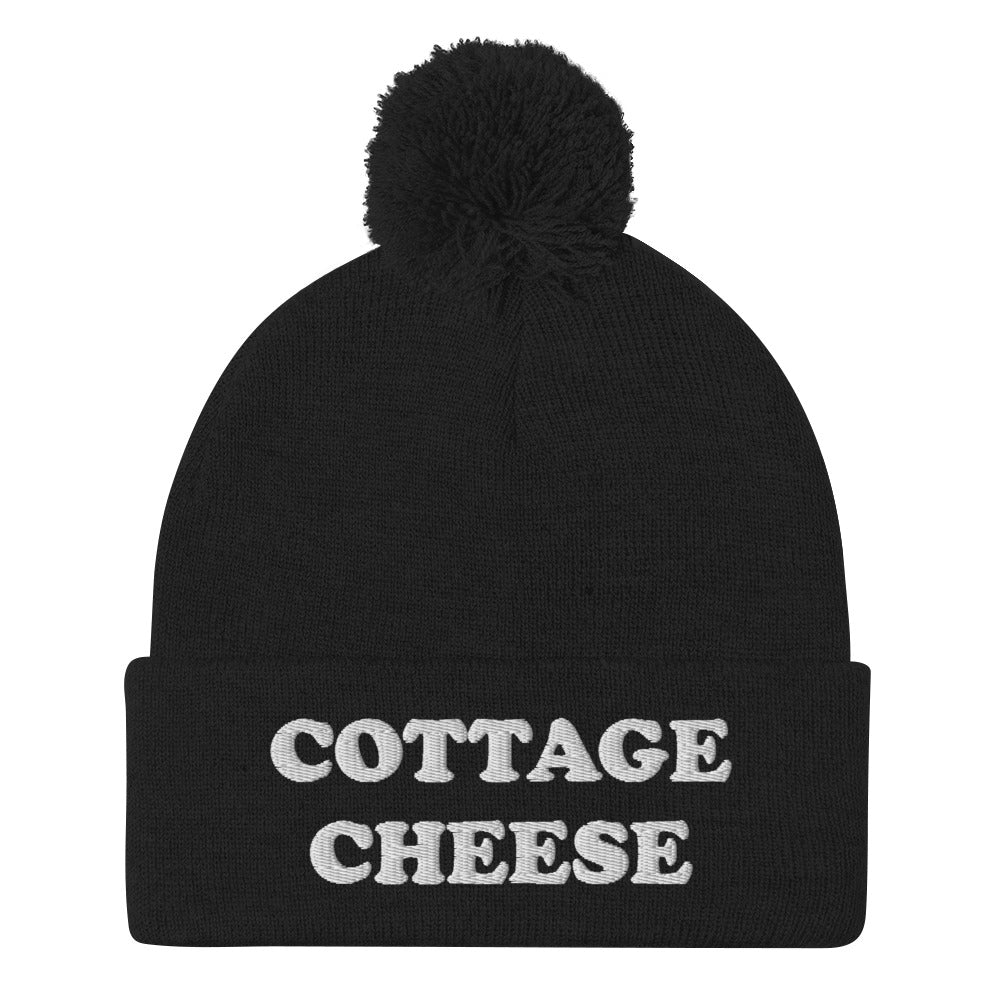 Black cottage cheese beanie from Nina's Funky Shop - Do you love cottage cheese? Looking for a funny gift for a cottage cheese enthusiast? This warm and cozy, embroidered beanie is just what you need. It's a classic pom pom beanie with "cottage cheese", expertly embroidered on the front. The perfect funny beanie for everyday streetwear and foodies of all kinds.