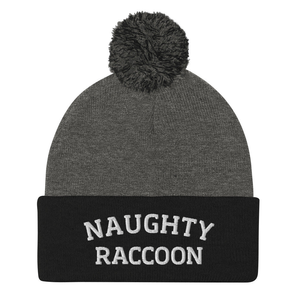 Gray and black naughty raccoon beanie from Nina's Funky Shop by ninanush - This Naughty Raccoon hat is warm, cozy, designed by Nina and made just for you. It's a comfortable unisex beanie with a pom pom on top, expertly embroidered with the words "naughty raccoon". The perfect weird beanie for raccoon enthusiasts and funny hat for quirky accessory lovers of all kinds. 