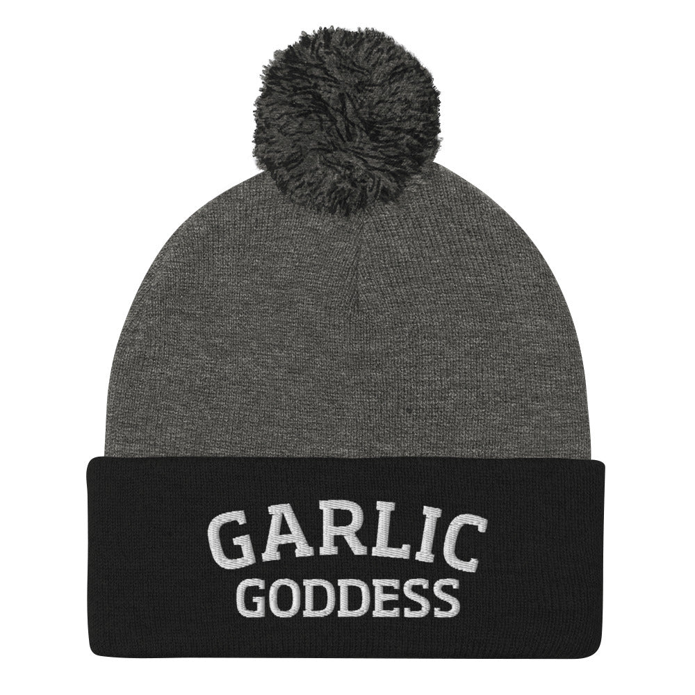 Black and gray garlic goddess beanie from Nina's Funky Shop by ninanush - GARLIC GODDESS ⚡ This garlic goddess hat is warm, cozy, designed by Nina and made just for you. It's a comfortable unisex garlic beanie with a pom pom on top, expertly embroidered with the words "garlic goddess". The perfect weird beanie for garlic lovers and funny garlic hat for garlic enthusiasts of all kinds.