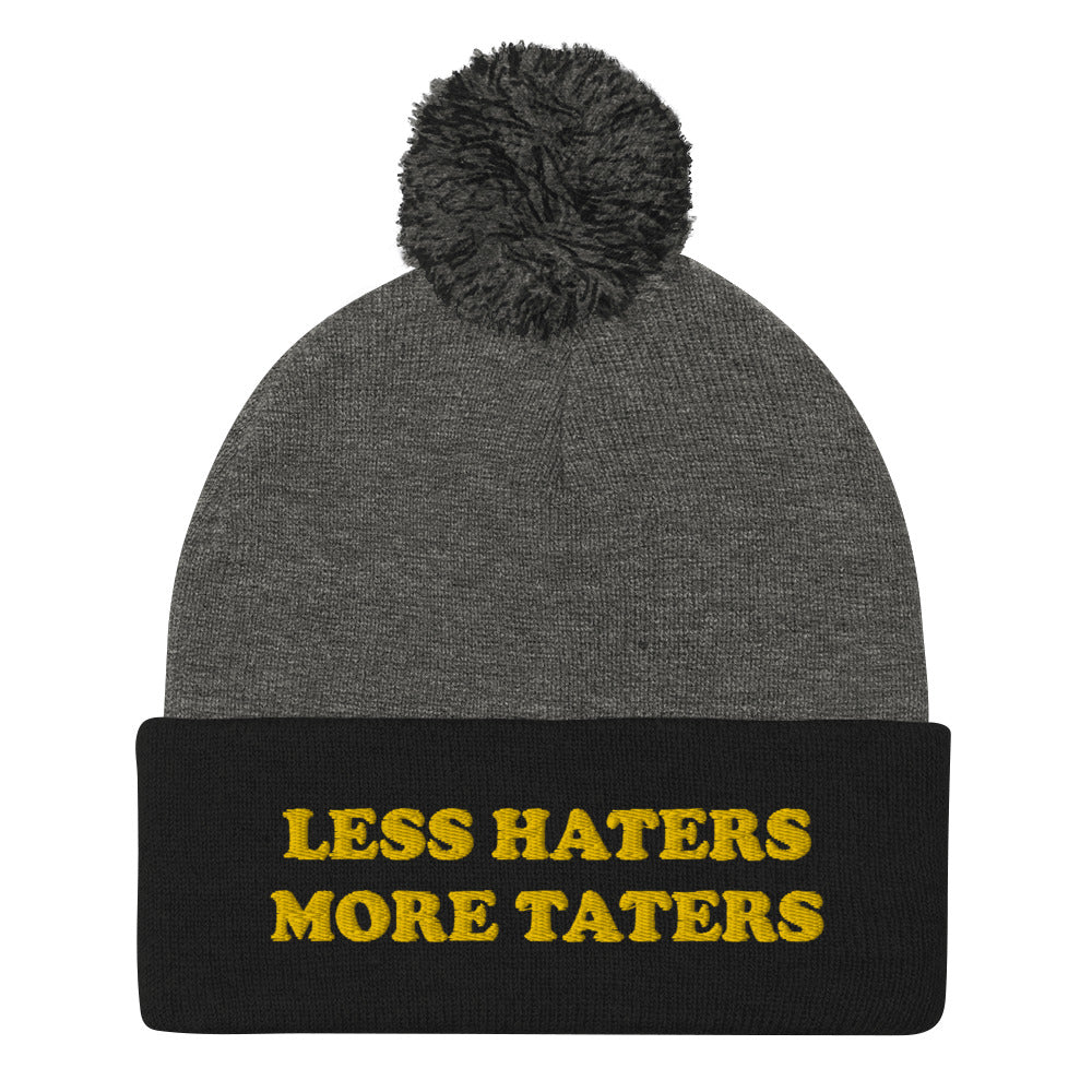 Black and Gray Less Haters More Taters Hat from Nina's Funky Shop - Lover potatoes? Looking for a funny gift? This warm and cozy, embroidered beanie is just what you need. It's a classic pom pom beanie with "less haters more taters", expertly embroidered on the front. The perfect funny beanie for potato enthusiasts and foodies of all kinds. Celebrate your favorite foods in our funky foodie apparel.