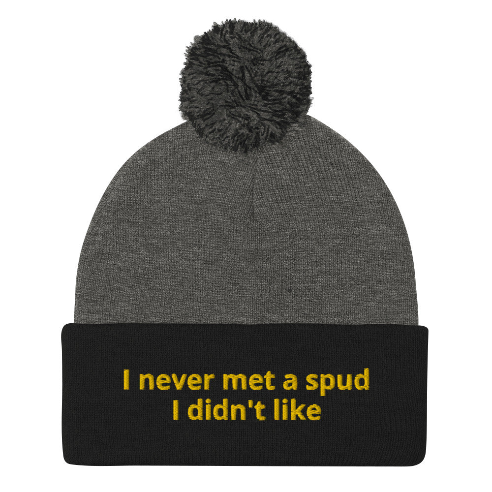 Navy and Black I Never Met A Spud I Didn't Like Dolly Beanie - Do you love potatoes? Looking for a funny gift for a potato enthusiast? This warm and cozy, embroidered beanie is just what you need. It's a classic pom pom beanie with "I never met a spud I didn't like", expertly embroidered on the front. The perfect funny beanie for everyday foodies and potato lovers of all kinds.