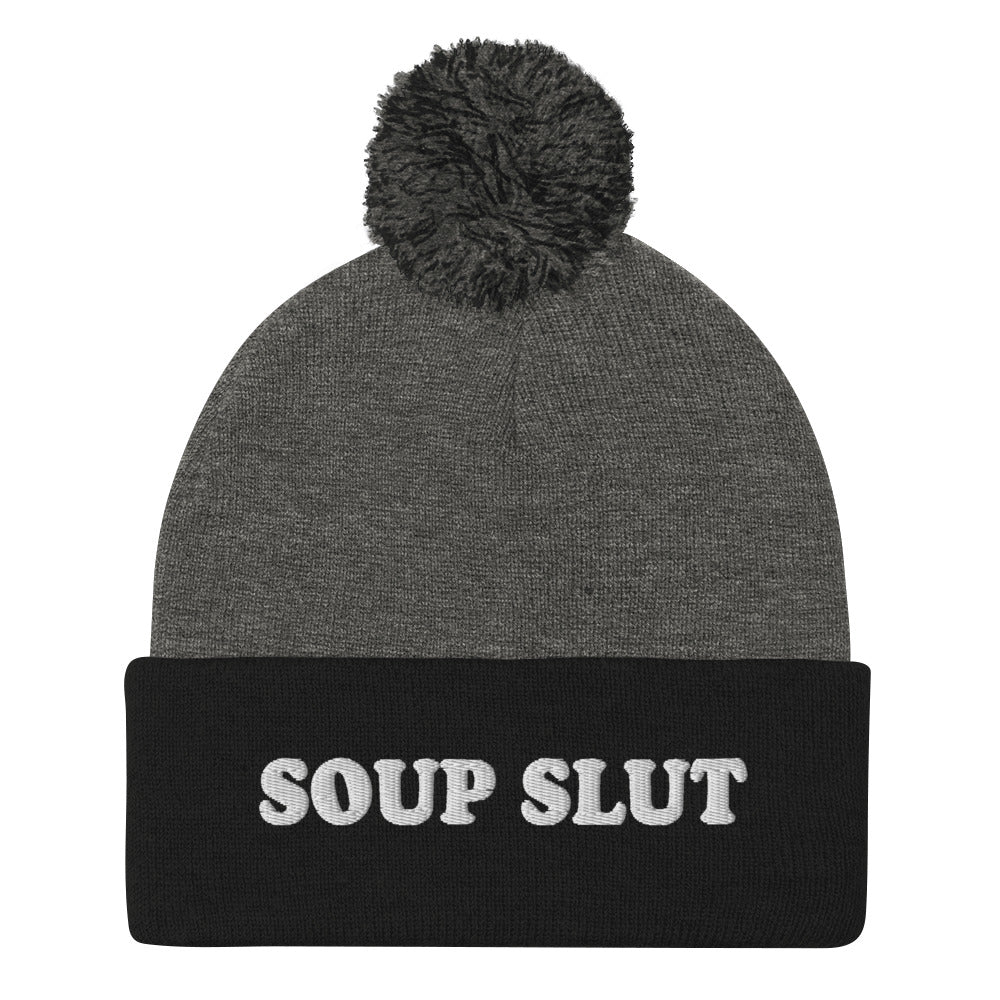 Gray and Black Embroidered Beanie with Soup Slut from Nina's Funky Shop - Love soup? Looking for a funny gift for a soup enthusiast? This warm and cozy, embroidered beanie is just what you need. It's a classic pom pom beanie with "soup slut", expertly embroidered on the front. The perfect weird beanie hat for soup sluts and foodies of all kinds. Celebrate your favorite foods in our funky foodie apparel.