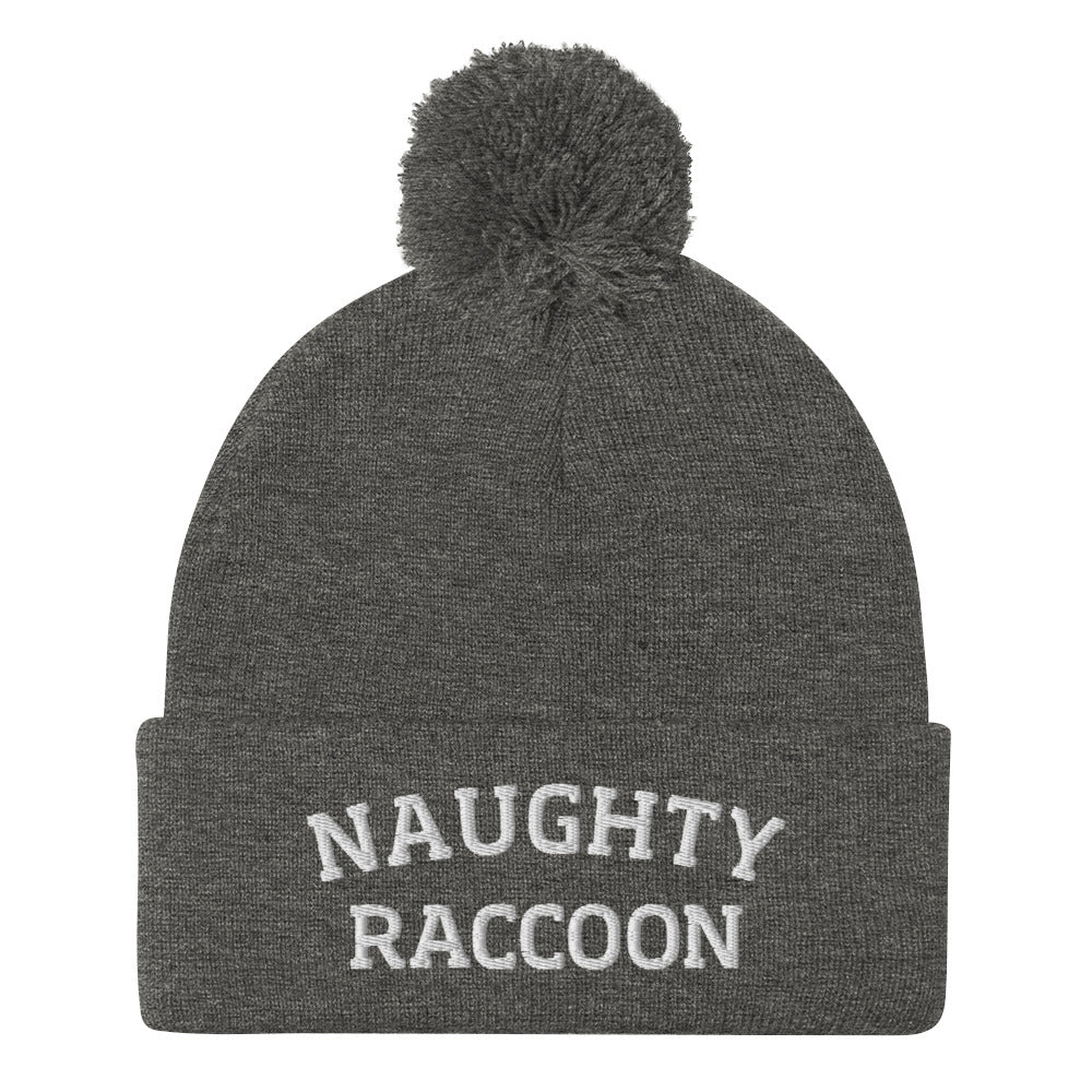 Dark heather gray naughty raccoon beanie from Nina's Funky Shop by ninanush - This Naughty Raccoon hat is warm, cozy, designed by Nina and made just for you. It's a comfortable unisex beanie with a pom pom on top, expertly embroidered with the words "naughty raccoon". The perfect weird beanie for raccoon enthusiasts and funny hat for quirky accessory lovers of all kinds.