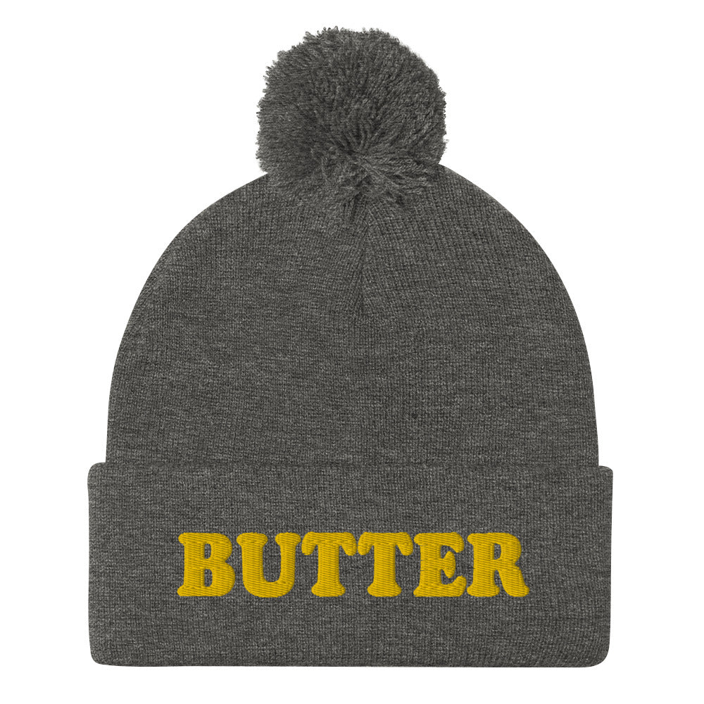 Gray Butter Beanie - Do you love butter? Looking for a funny gift for a butter enthusiast? This warm and cozy, embroidered beanie is just what you need. It's a classic pom pom beanie with "butter", expertly embroidered on the front. The perfect funny beanie for butter lovers and foodies of all kinds. Celebrate your favorite foods in our funky foodie apparel.