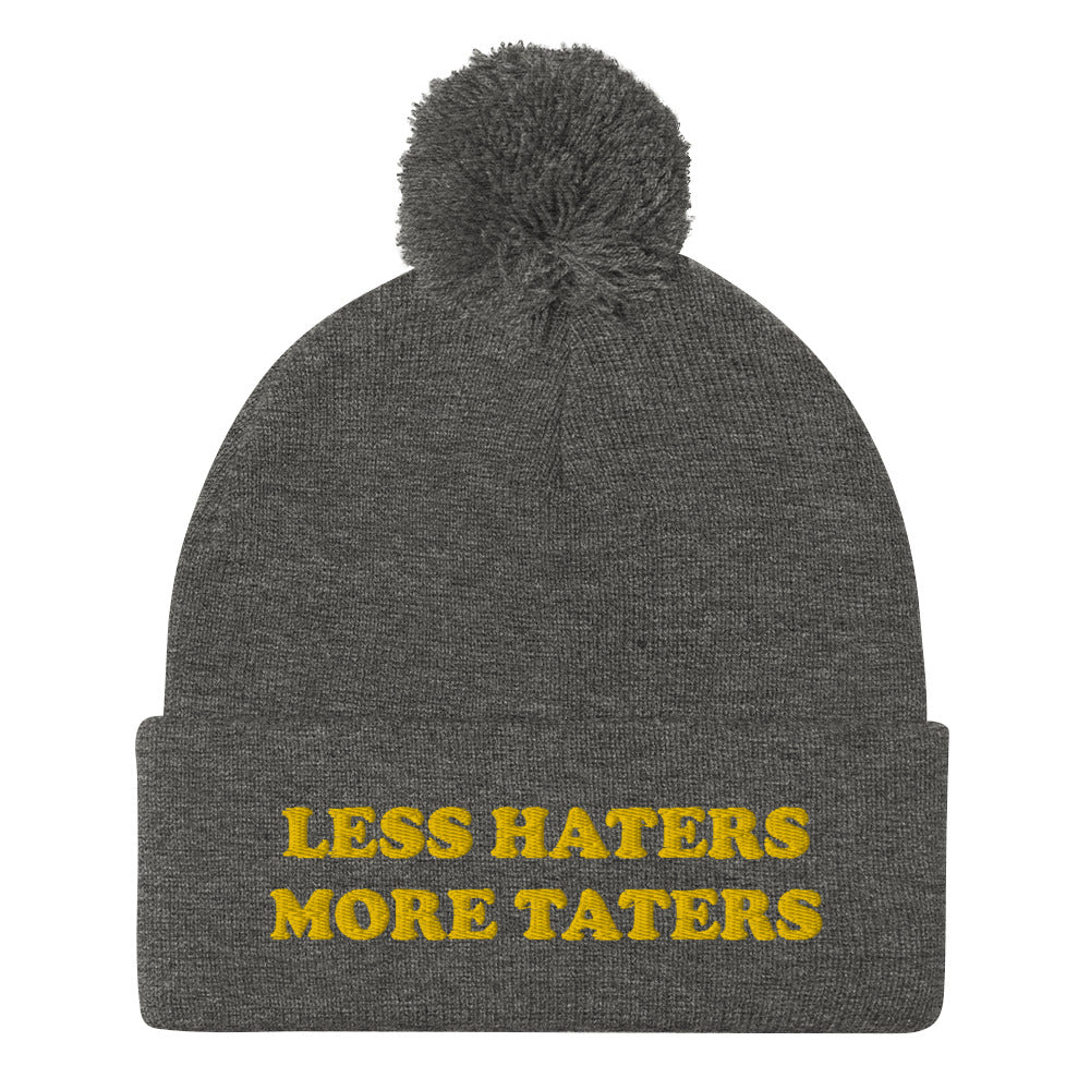 Dark Gray Less Haters More Taters Hat from Nina's Funky Shop - Lover potatoes? Looking for a funny gift? This warm and cozy, embroidered beanie is just what you need. It's a classic pom pom beanie with "less haters more taters", expertly embroidered on the front. The perfect funny beanie for potato enthusiasts and foodies of all kinds. Celebrate your favorite foods in our funky foodie apparel.