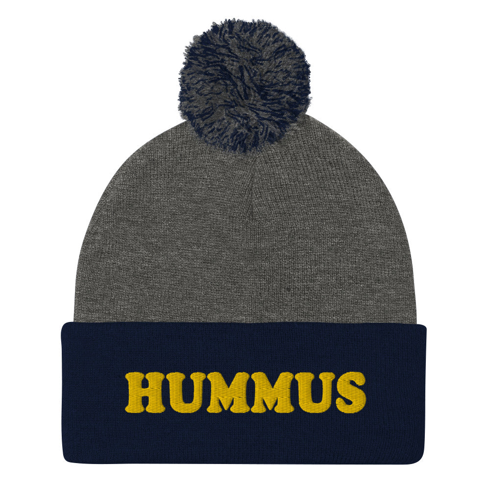 Navy and Gray Beanie with Hummus Embroidered on the front in yellow - Do you love hummus? Looking for a funny gift for a foodie? This warm and cozy, embroidered beanie is just what you need. It's a classic pom pom beanie with "HUMMUS", embroidered on the front. The perfect funny beanie for hummus lovers and foodies of all kinds. Celebrate your favorite foods in our funky foodie apparel.