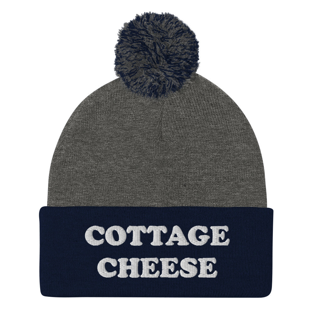 Gray and Blue cottage cheese beanie from Nina's Funky Shop - Do you love cottage cheese? Looking for a funny gift for a cottage cheese enthusiast? This warm and cozy, embroidered beanie is just what you need. It's a classic pom pom beanie with "cottage cheese", expertly embroidered on the front. The perfect funny beanie for everyday streetwear and foodies of all kinds. 