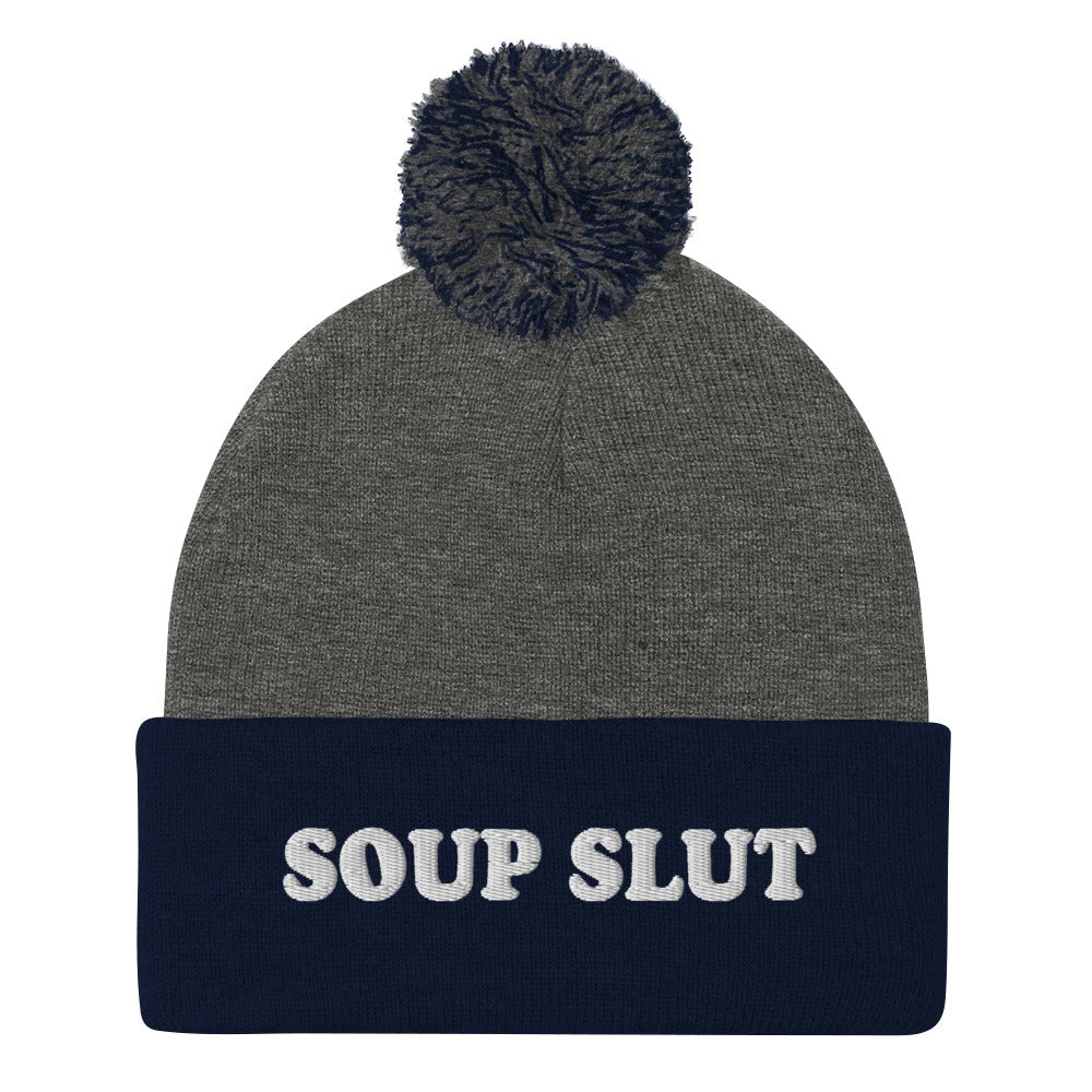 Navy and Gray Embroidered Beanie with Soup Slut from Nina's Funky Shop - Love soup? Looking for a funny gift for a soup enthusiast? This warm and cozy, embroidered beanie is just what you need. It's a classic pom pom beanie with "soup slut", expertly embroidered on the front. The perfect weird beanie hat for soup sluts and foodies of all kinds. Celebrate your favorite foods in our funky foodie apparel.