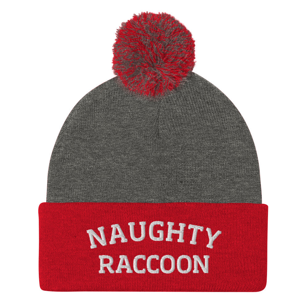 Gray and red naughty raccoon beanie from Nina's Funky Shop by ninanush - This Naughty Raccoon hat is warm, cozy, designed by Nina and made just for you. It's a comfortable unisex beanie with a pom pom on top, expertly embroidered with the words "naughty raccoon". The perfect weird beanie for raccoon enthusiasts and funny hat for quirky accessory lovers of all kinds.