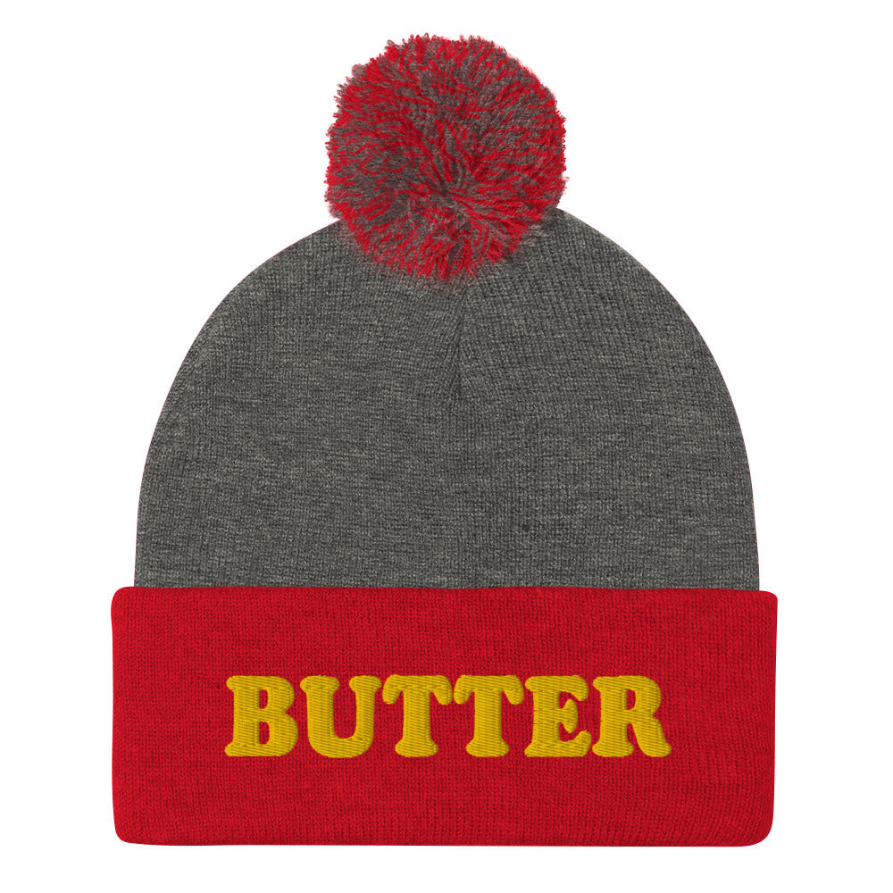 Gray and Red Butter Beanie - Do you love butter? Looking for a funny gift for a butter enthusiast? This warm and cozy, embroidered beanie is just what you need. It's a classic pom pom beanie with "butter", expertly embroidered on the front. The perfect funny beanie for butter lovers and foodies of all kinds. Celebrate your favorite foods in our funky foodie apparel.