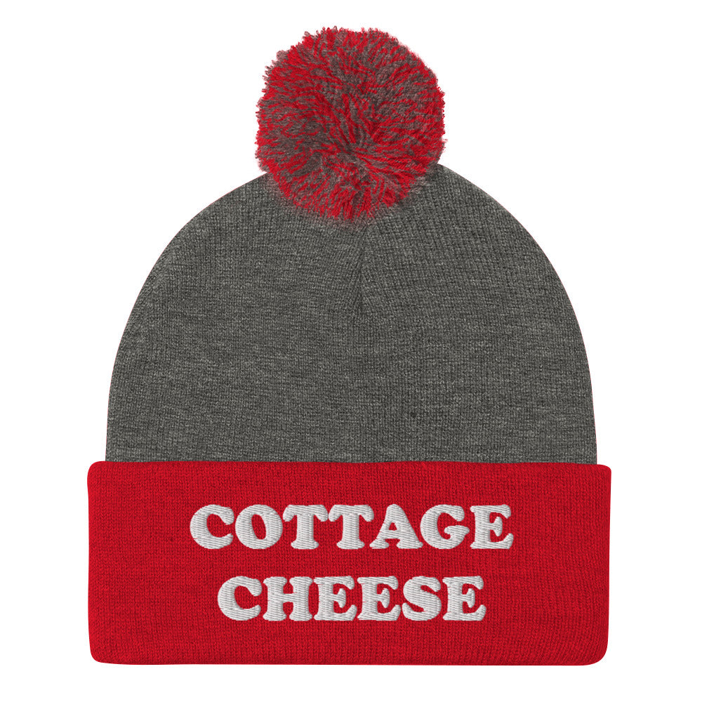 Red and gray cottage cheese beanie from Nina's Funky Shop - Do you love cottage cheese? Looking for a funny gift for a cottage cheese enthusiast? This warm and cozy, embroidered beanie is just what you need. It's a classic pom pom beanie with "cottage cheese", expertly embroidered on the front. The perfect funny beanie for everyday streetwear and foodies of all kinds.