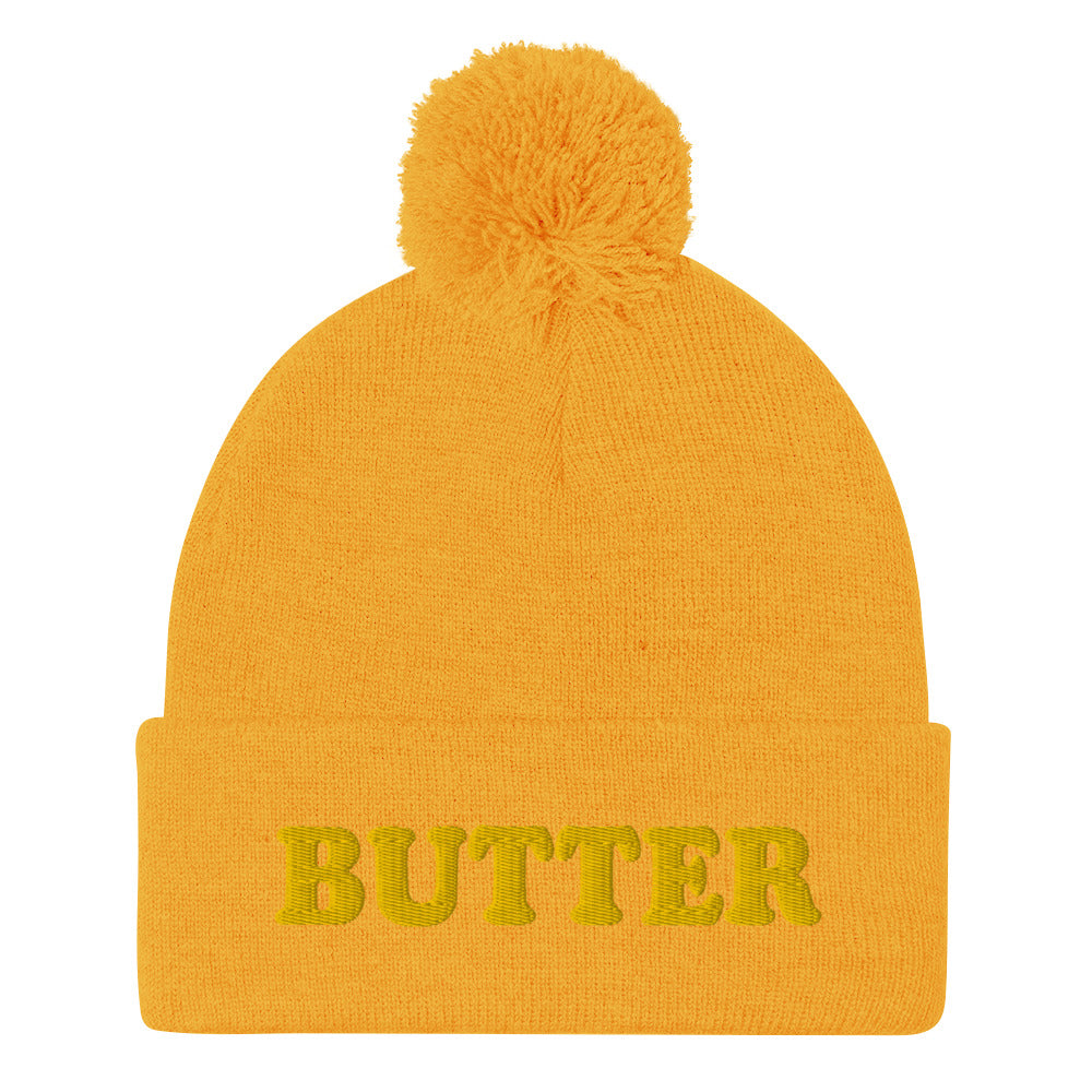 Yellow Butter Beanie - Do you love butter? Looking for a funny gift for a butter enthusiast? This warm and cozy, embroidered beanie is just what you need. It's a classic pom pom beanie with "butter", expertly embroidered on the front. The perfect funny beanie for butter lovers and foodies of all kinds. Celebrate your favorite foods in our funky foodie apparel.