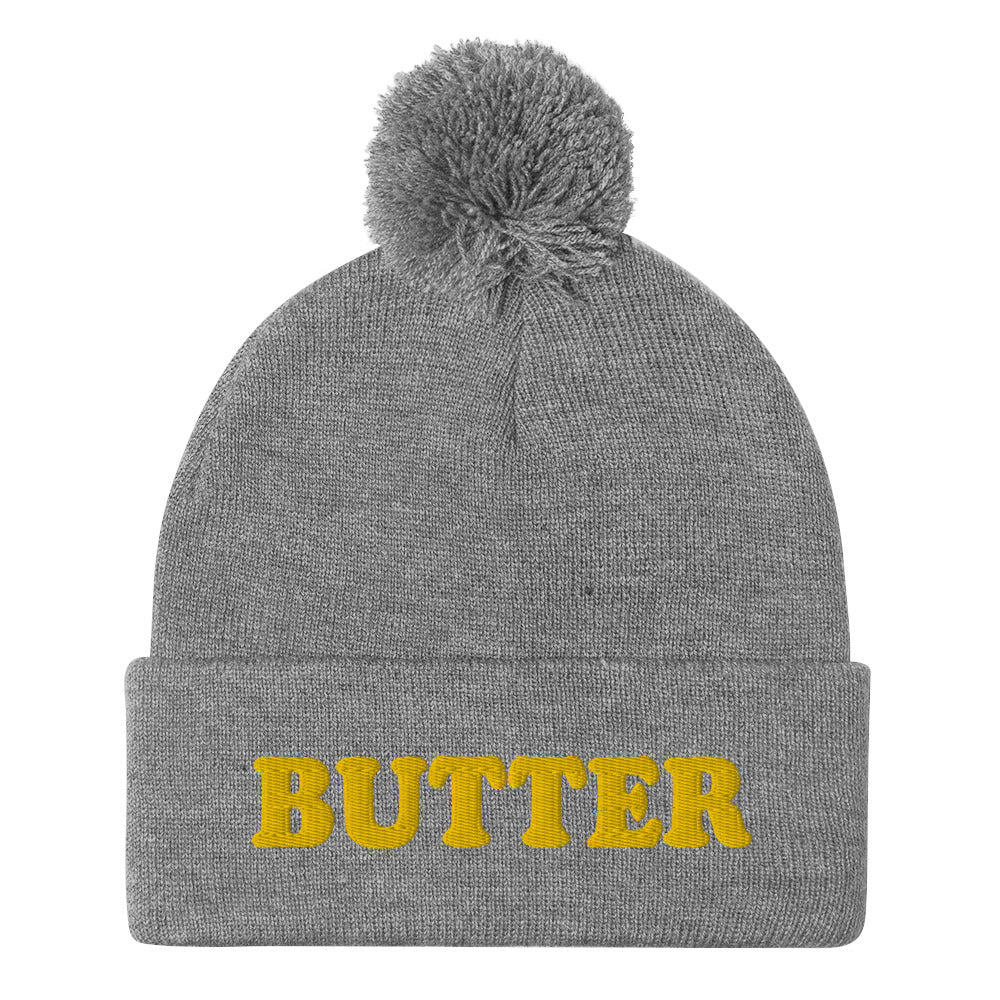 Gray Butter Beanie - Do you love butter? Looking for a funny gift for a butter enthusiast? This warm and cozy, embroidered beanie is just what you need. It's a classic pom pom beanie with "butter", expertly embroidered on the front. The perfect funny beanie for butter lovers and foodies of all kinds. Celebrate your favorite foods in our funky foodie apparel.