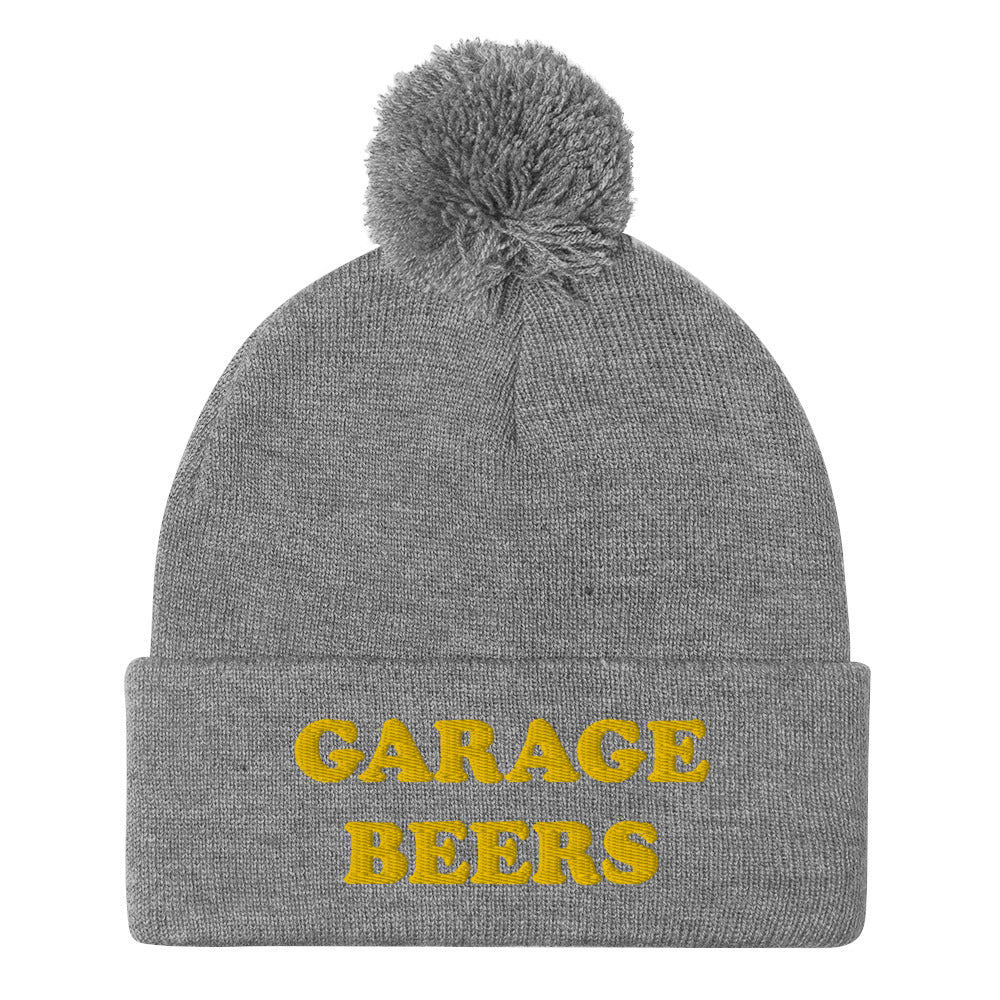 Light Gray Garage Beers Beanie from Nina's Funky Shop - Love beer? Looking for a funny gift for a friend? This warm and cozy, embroidered beer beanie is just what you need. It's a classic pom pom beanie with "garage beers", expertly embroidered on the front. The perfect funny beanie for beer lovers. Celebrate your favorite foods in our funky foodie apparel.