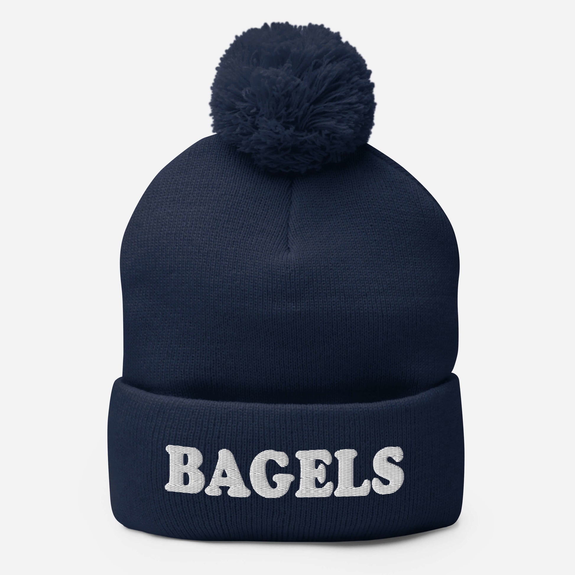 Navy Bagels Beanie -Are you a bagel enthusiast? Looking for a gift for a foodie? Our Bagels Beanie is comfortable, cozy and expertly embroidered just for you. It's a funny beanie with a pom pom on top, perfect for everyday streetwear for bagel lovers and foodies of all kinds. 