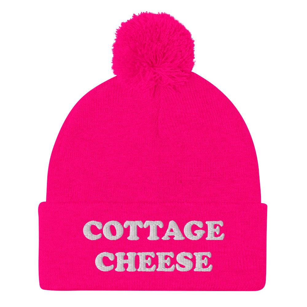 Neon Pink cottage cheese beanie from Nina's Funky Shop - Do you love cottage cheese? Looking for a funny gift for a cottage cheese enthusiast? This warm and cozy, embroidered beanie is just what you need. It's a classic pom pom beanie with "cottage cheese", expertly embroidered on the front. The perfect funny beanie for everyday streetwear and foodies of all kinds.