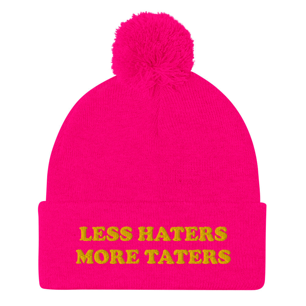 Neon Pink Less Haters More Taters Hat from Nina's Funky Shop - Lover potatoes? Looking for a funny gift? This warm and cozy, embroidered beanie is just what you need. It's a classic pom pom beanie with "less haters more taters", expertly embroidered on the front. The perfect funny beanie for potato enthusiasts and foodies of all kinds. Celebrate your favorite foods in our funky foodie apparel.