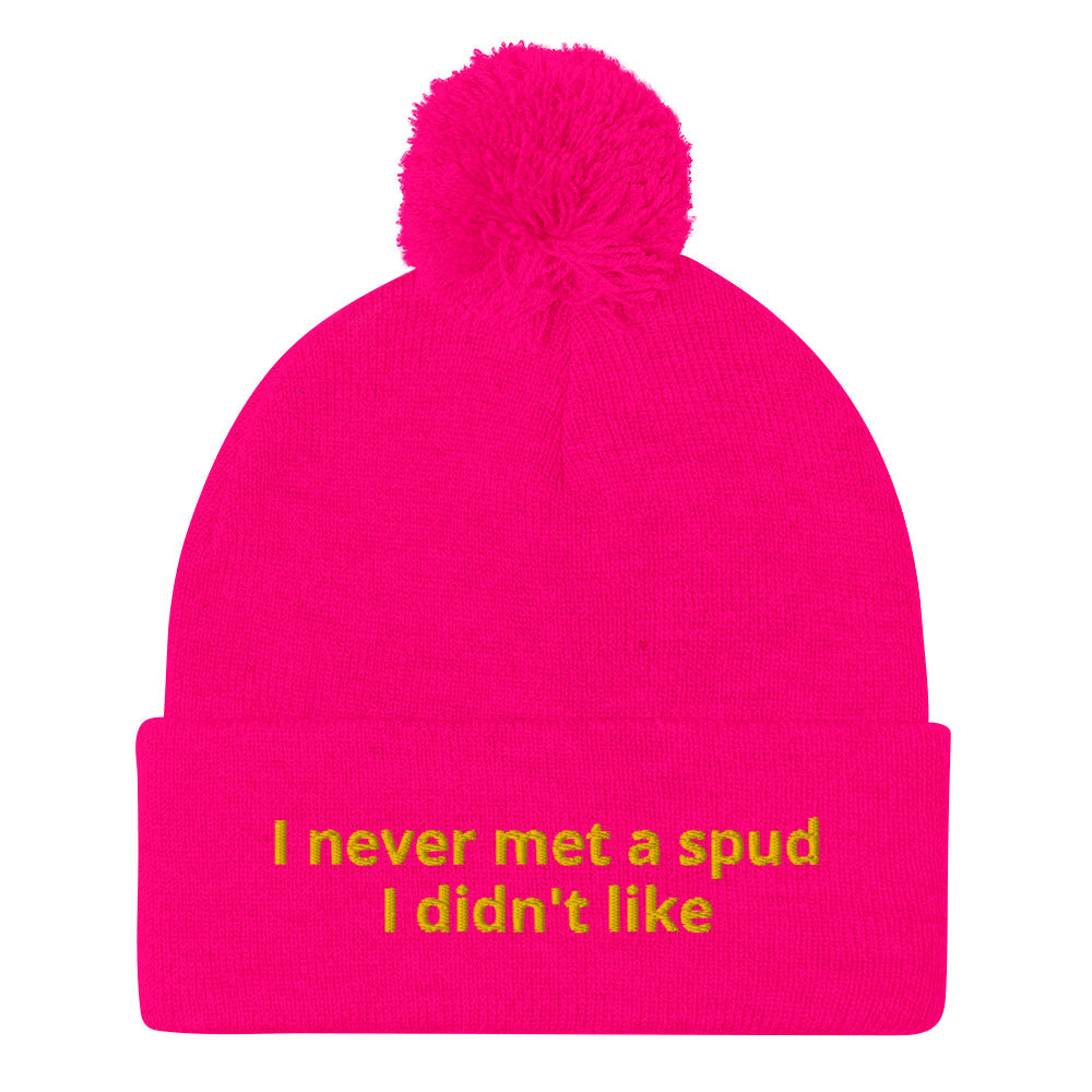 Pink I Never Met A Spud I Didn't Like Dolly Beanie - Do you love potatoes? Looking for a funny gift for a potato enthusiast? This warm and cozy, embroidered beanie is just what you need. It's a classic pom pom beanie with "I never met a spud I didn't like", expertly embroidered on the front. The perfect funny beanie for everyday foodies and potato lovers of all kinds.