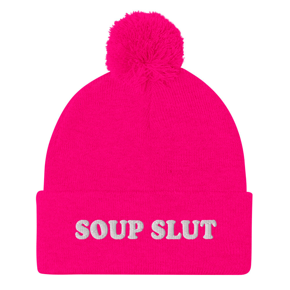 Pink Embroidered Beanie with Soup Slut from Nina's Funky Shop - Love soup? Looking for a funny gift for a soup enthusiast? This warm and cozy, embroidered beanie is just what you need. It's a classic pom pom beanie with "soup slut", expertly embroidered on the front. The perfect weird beanie hat for soup sluts and foodies of all kinds. Celebrate your favorite foods in our funky foodie apparel.