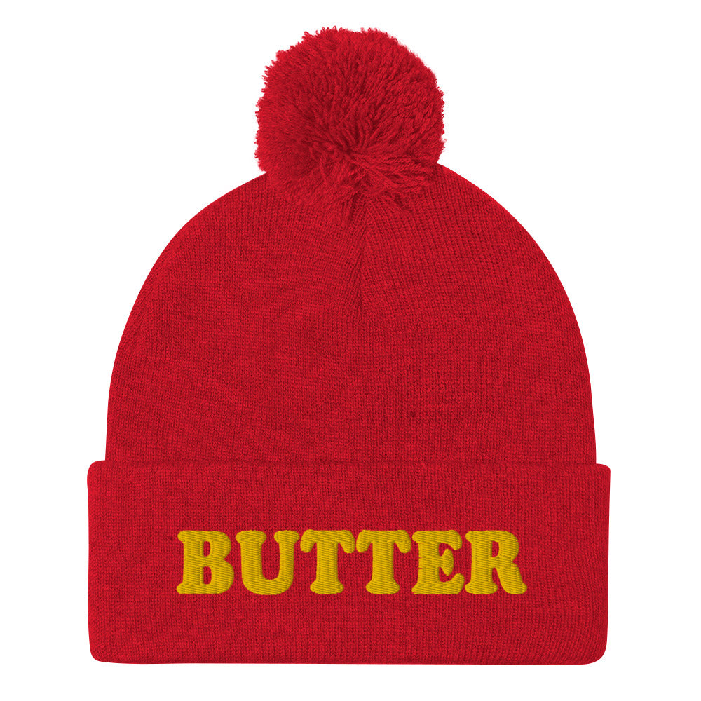 Red Butter Beanie - Do you love butter? Looking for a funny gift for a butter enthusiast? This warm and cozy, embroidered beanie is just what you need. It's a classic pom pom beanie with "butter", expertly embroidered on the front. The perfect funny beanie for butter lovers and foodies of all kinds. Celebrate your favorite foods in our funky foodie apparel.