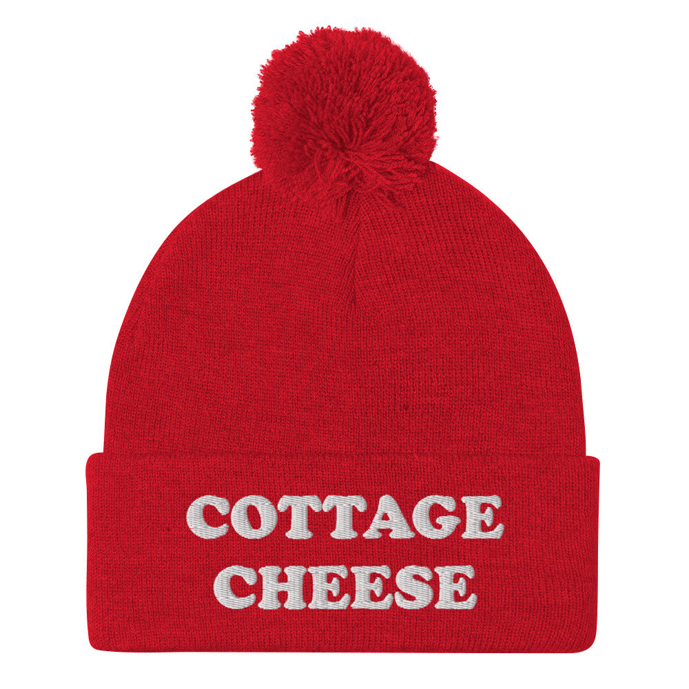 Red cottage cheese beanie from Nina's Funky Shop - Do you love cottage cheese? Looking for a funny gift for a cottage cheese enthusiast? This warm and cozy, embroidered beanie is just what you need. It's a classic pom pom beanie with "cottage cheese", expertly embroidered on the front. The perfect funny beanie for everyday streetwear and foodies of all kinds.